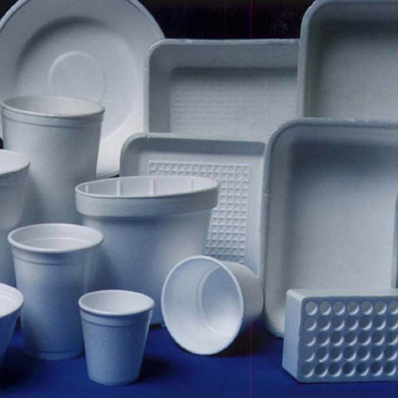 Assorted white disposable tableware including cups, plates, and trays