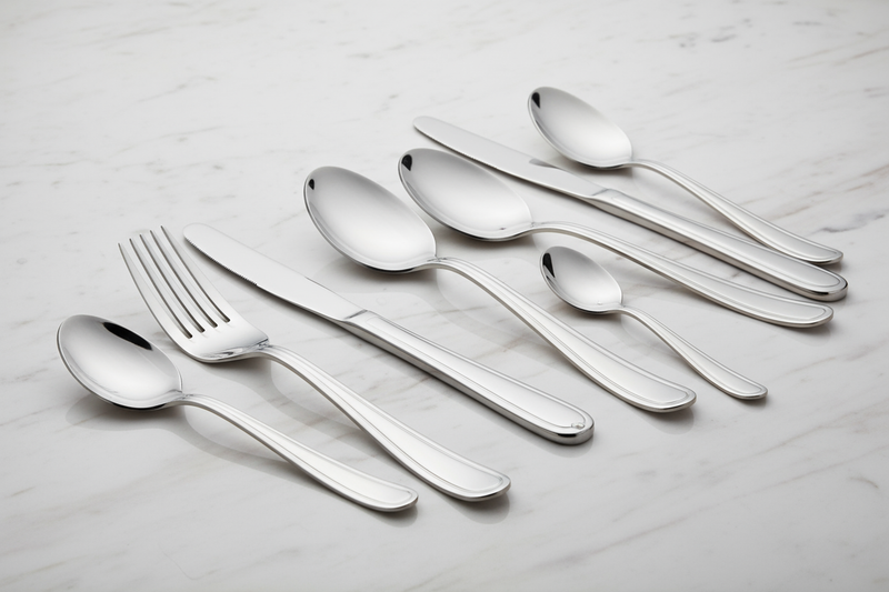 Elegant rose gold knife and cutlery set on a formal dining table.