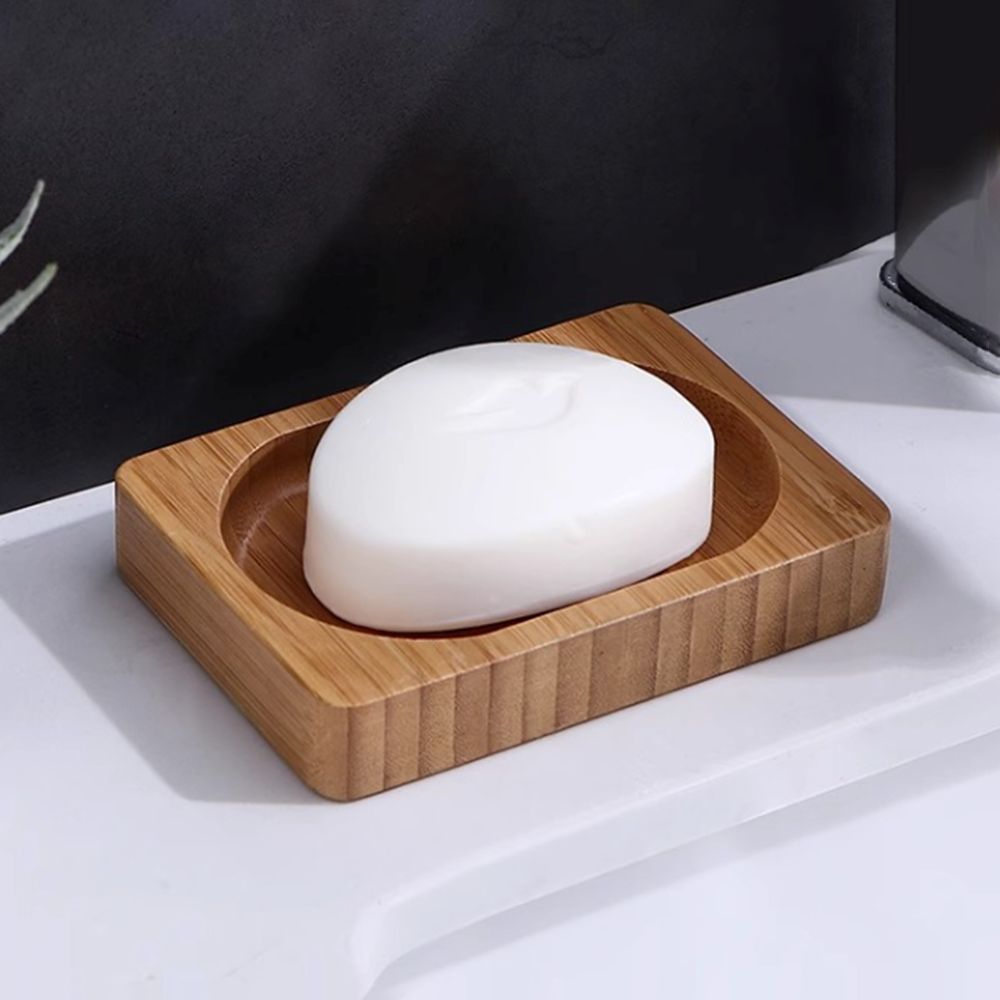 Wooden Soap Tray Dish with white soap bar placed on a bathroom sink, eco-friendly bamboo design for modern bathroom decor.