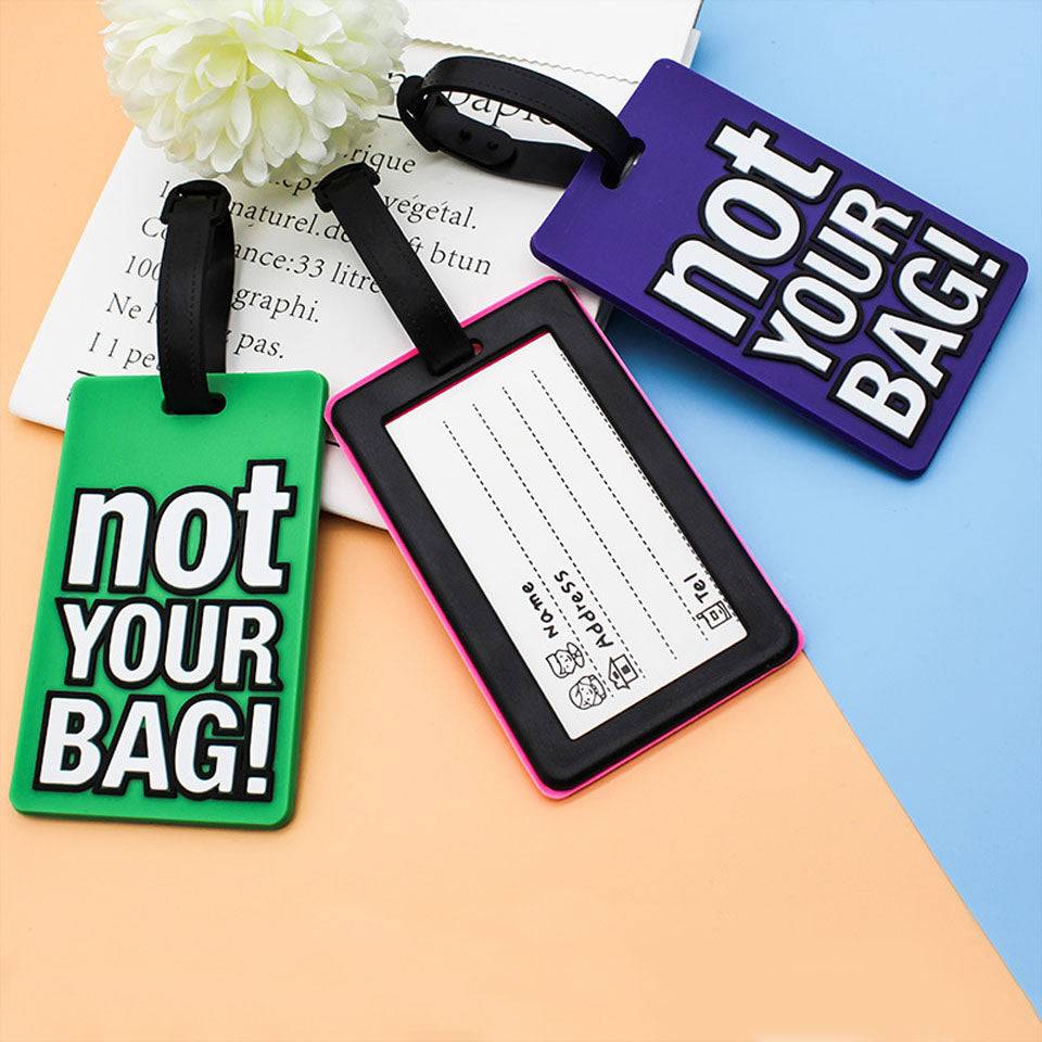 Back view of Travel Luggage Tag 'NOT YOUR BAG' showing ID card slot and strap lock. Perfect travel accessory for secure and stylish luggage tagging.