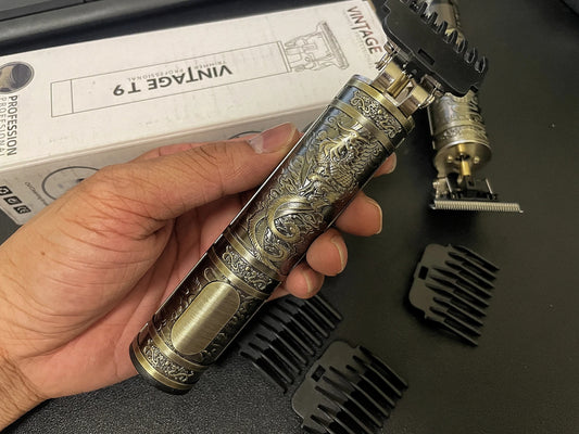 Hand holding the Professional Hair Clipper WS-T789 featuring a vintage engraved design, perfect for detailed personal grooming.