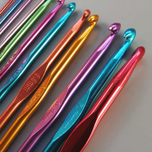 Close-up of colorful aluminum crochet hooks showing engraved size markings, part of the 12PCS set for precise wool weaving and knitting.