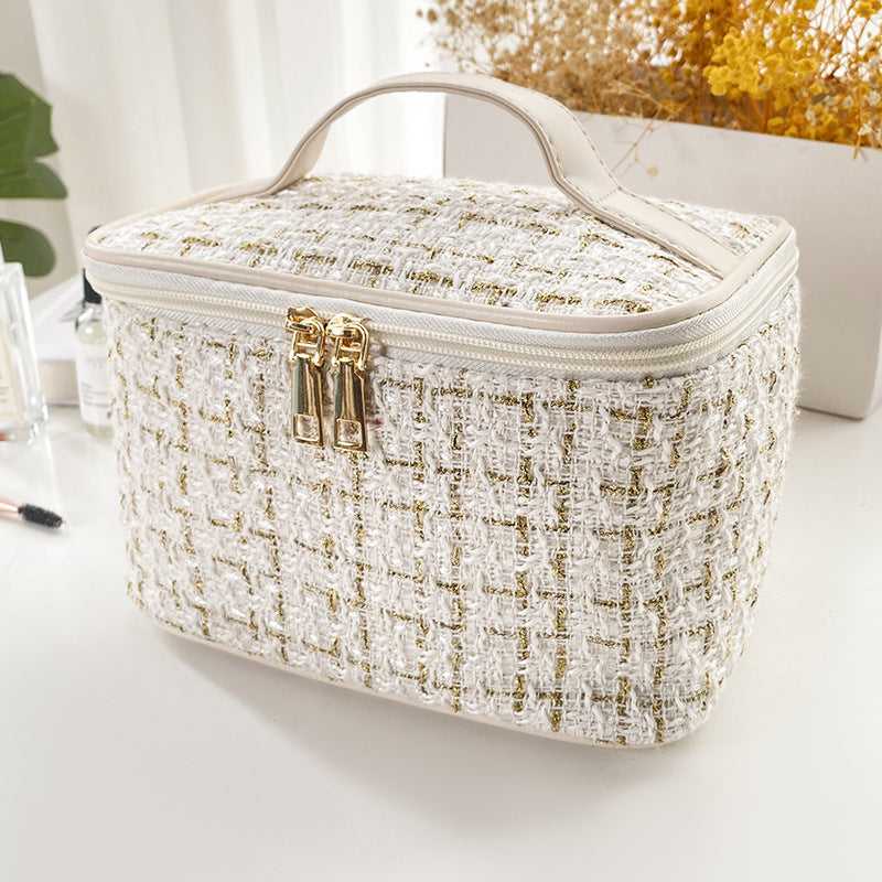 Large Capacity Cosmetic Makeup Bag for Professionals with textured white and gold tweed fabric, dual zipper, and top handle for easy carrying.