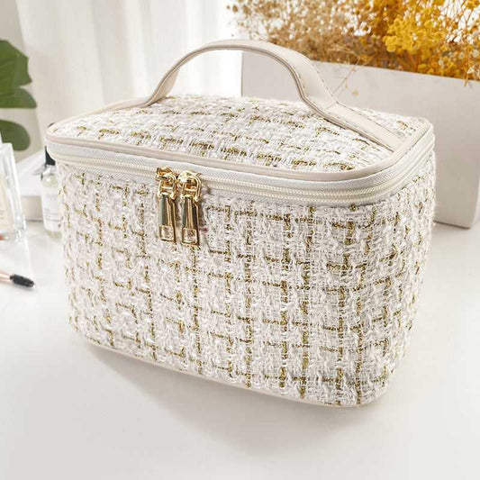 Large Capacity Cosmetic Makeup Bag for Professionals with textured white and gold tweed fabric, dual zipper, and top handle for easy carrying.