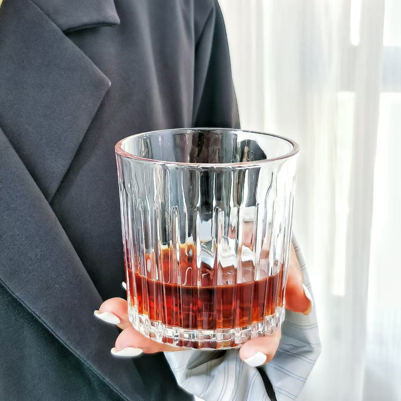 335ml stripped whisky bar glass held in hand, showcasing its vertical ribbed design ideal for whisky tasting and elegant presentation.