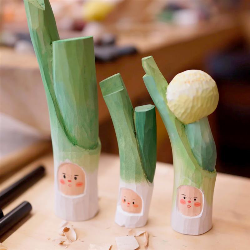 Finished wood carvings of painted vegetable characters made using the Woodworking Carving Knife Tools 5 PCS, perfect for arts and crafts.