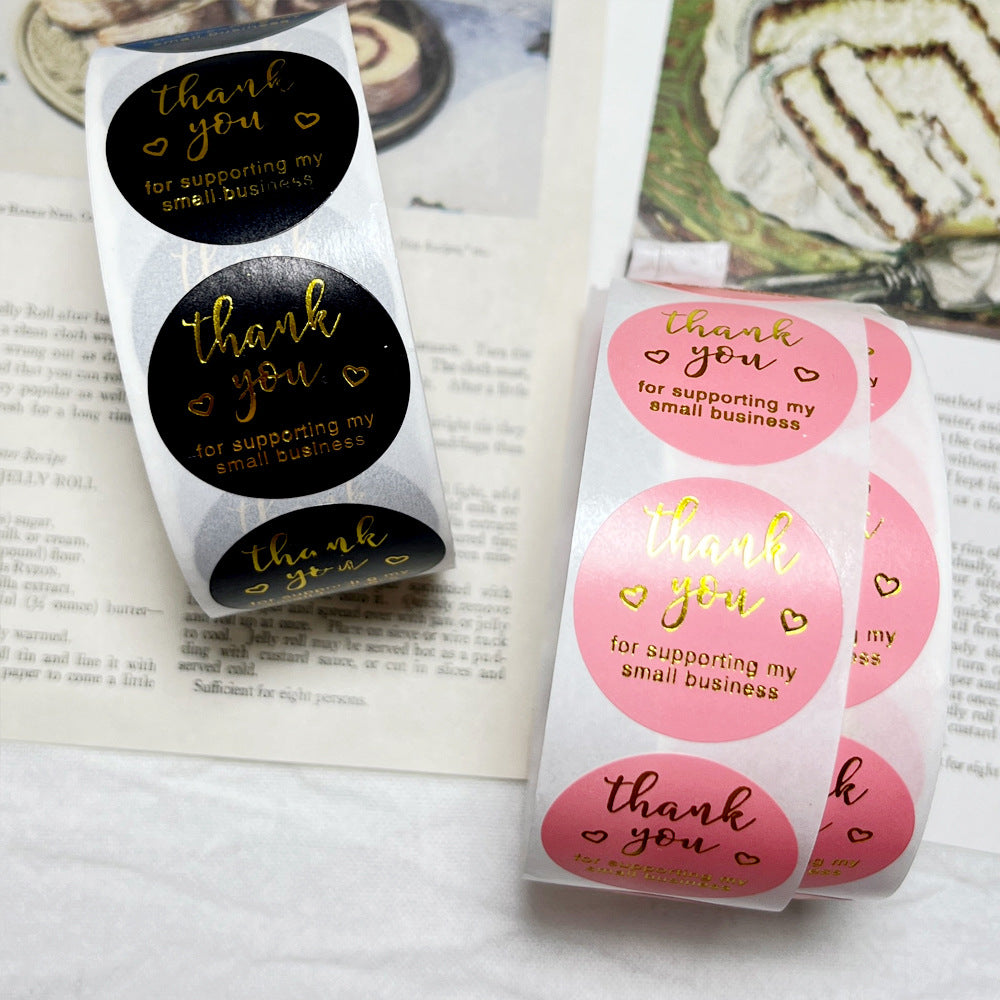 Close-up of 500 PCS Pink Thank You Stickers in black and pink designs, used for small business packaging and gift labeling from Bamagate.com.