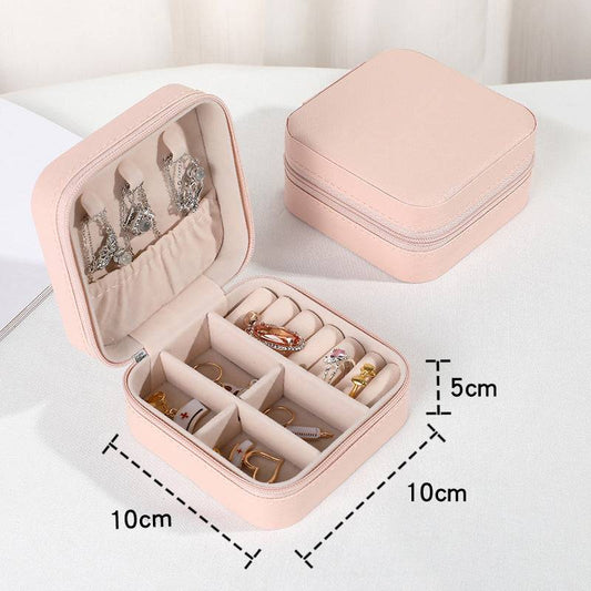 Mini Portable Jewelry Storage Box in soft pink with compartments for rings, earrings, and necklaces. Compact 10cm x 10cm x 5cm design for travel.