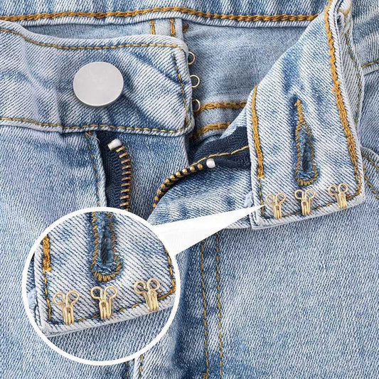 Close-up of brass sewing hooks & eye closures attached to denim jeans, demonstrating durable fastening for clothing repairs.