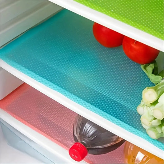 Refrigerator Silicone Shelf Liner 30 x 45 cm in blue, green, and red used on fridge shelves for non-slip spill protection and food organization.