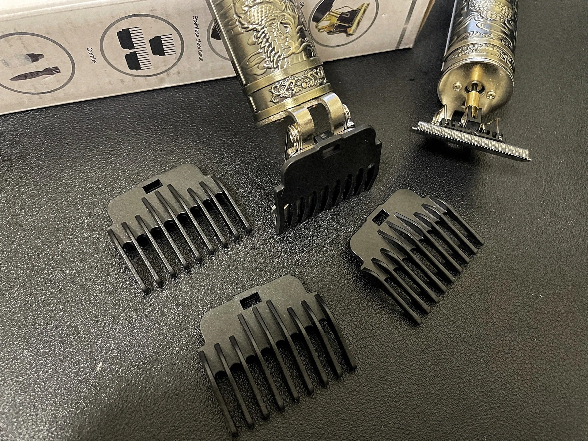 Professional Hair Clipper WS-T789 with ornate metal body and detachable guide combs, ideal for precise grooming and hair trimming.