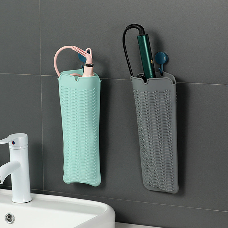 Heat Mat For Hair Straighteners hanging on a bathroom wall, storing hot tools safely with anti-scalding silicone design.