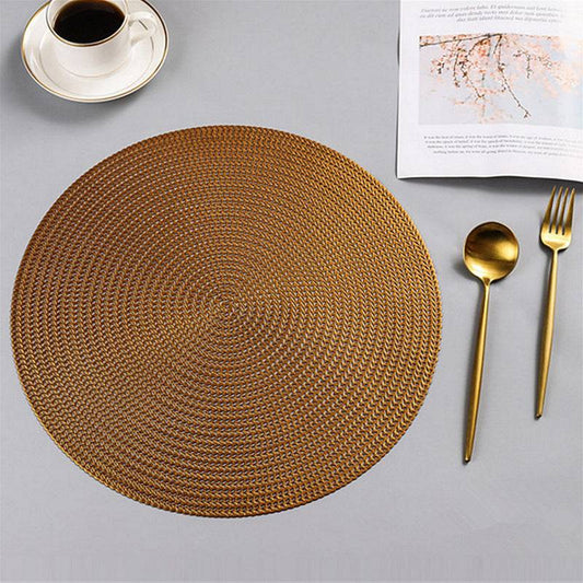 Gold Round PVC Table Placemat 38cm displayed on a dining table with gold cutlery and coffee cup, ideal for elegant table settings.