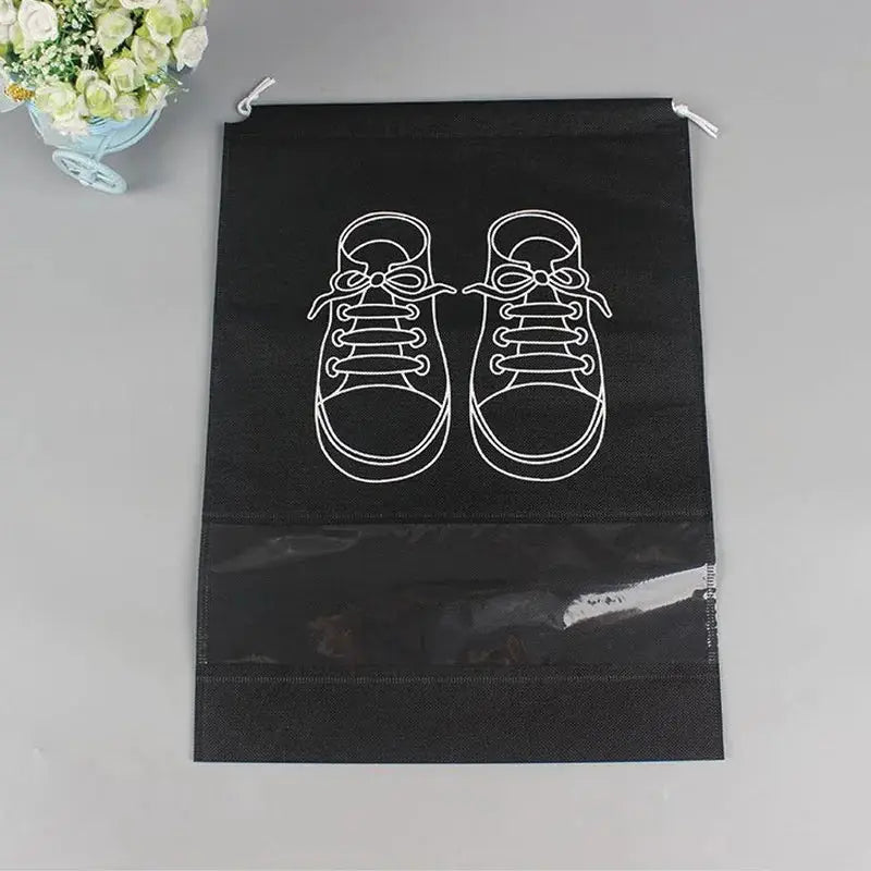 Black shoe storage bag with sneaker print and clear window, ideal for travel and home use to protect and organize footwear.