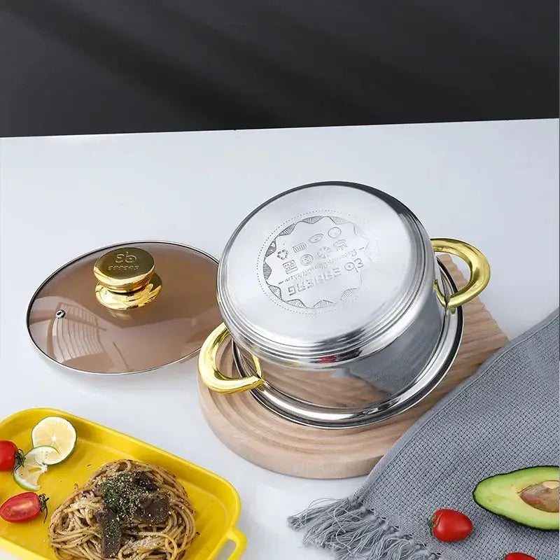 Bottom view of Stainless Steel Cookware Set 12PCS pot showing induction base, placed beside cooked pasta and fresh vegetables.