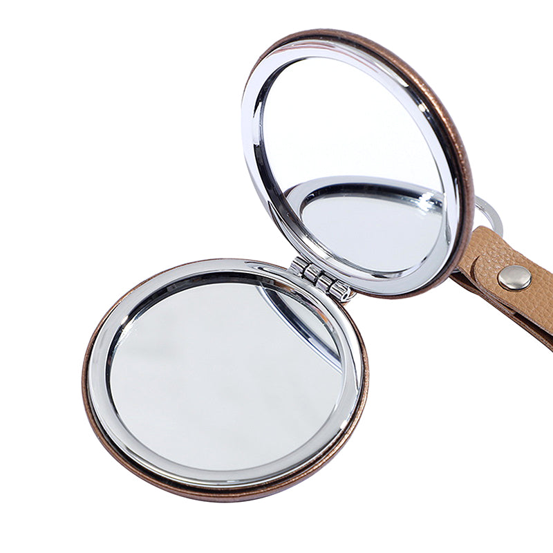 Portable Double-Sided Folding Mirror with brown leather frame and chrome edges, ideal for travel and daily makeup use. Compact face mirror for women.