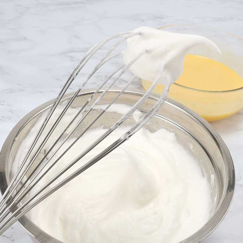 Durable 14-inch Stainless Steel Wire Egg Beater shown with ergonomic handle, perfect for mixing eggs and batters in home kitchen settings.