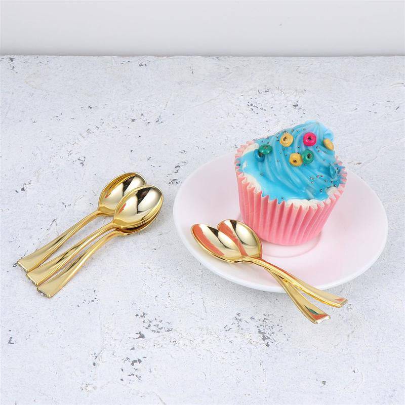 Gold Tea Spoon Set - Gold Tea Spoons | 6 PCs Stainless Steel displayed beside a cupcake on a white plate. Elegant flatware for tea time or dessert.