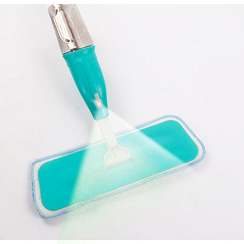Close-up of Healthy Spray Mop spraying water from nozzle onto blue microfiber pad, highlighting cleaning efficiency.
