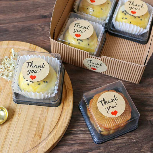 Thank you stickers on bakery packaging, adding a personal touch to food containers for branding and customer appreciation.