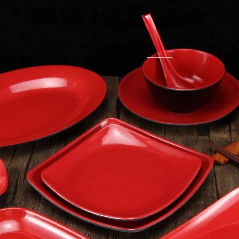 Set of Black Red Melamine Serving Plates 26cm with matching bowls and ladles, perfect for stylish and coordinated table settings.