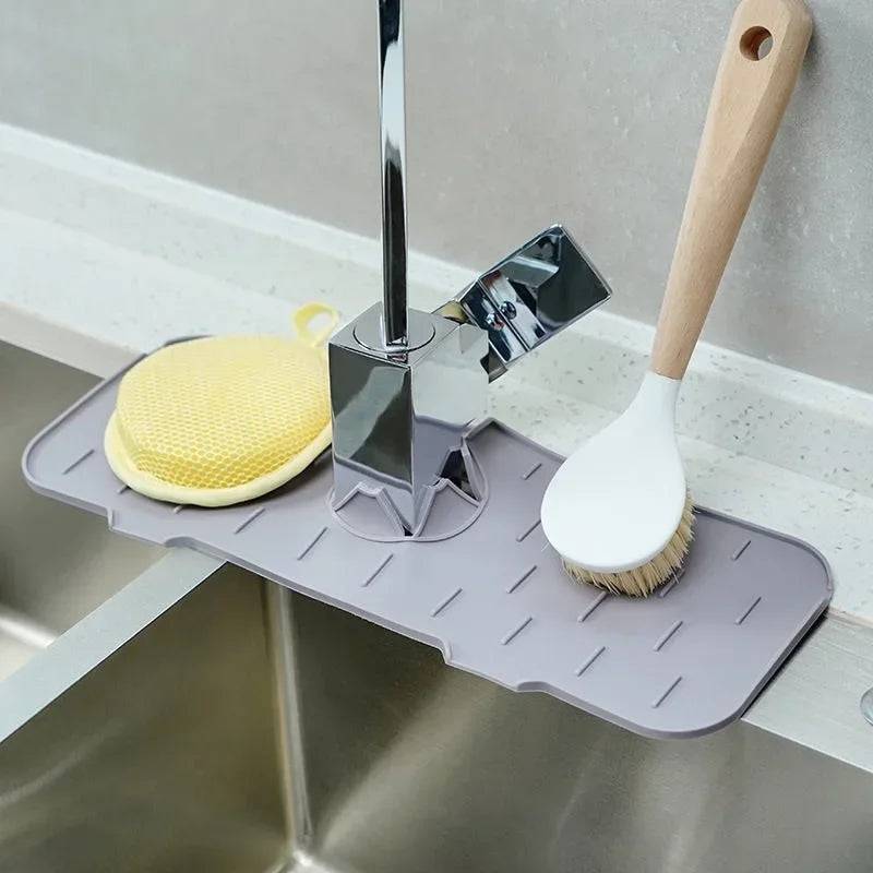 Kitchen Sink Portable Mat used as a drip tray for faucet area, holding cleaning tools like brush and sponge. Perfect for organized sink space.