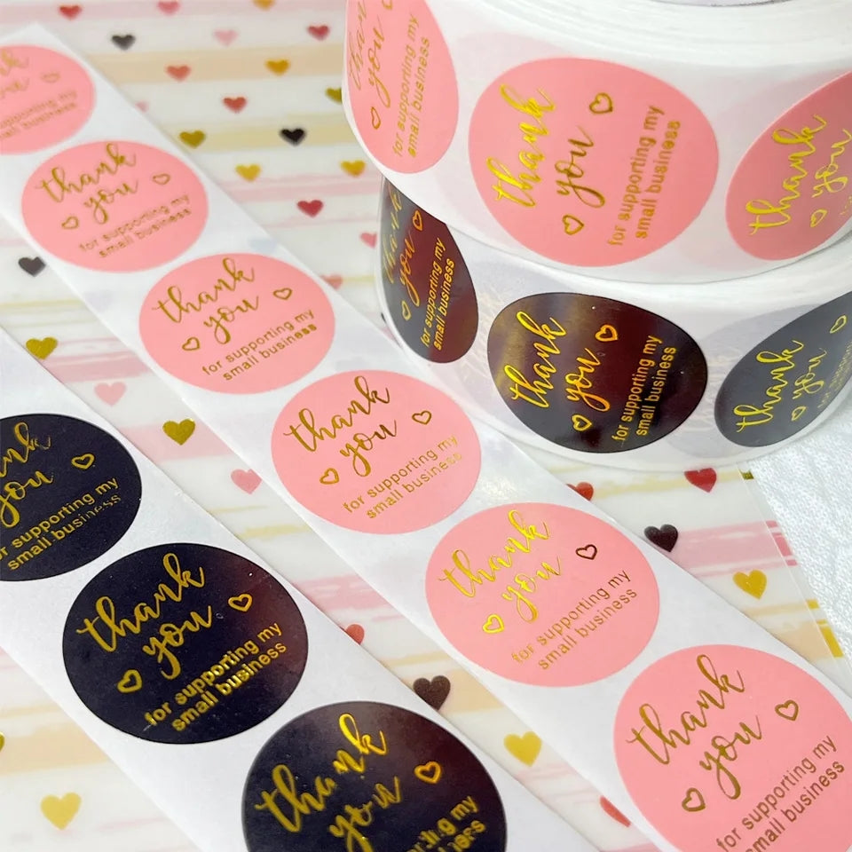 500 PCS Pink Thank You Stickers in rolls with gold foil text, ideal for labeling gifts or packaging. Perfect for small business appreciation tags.