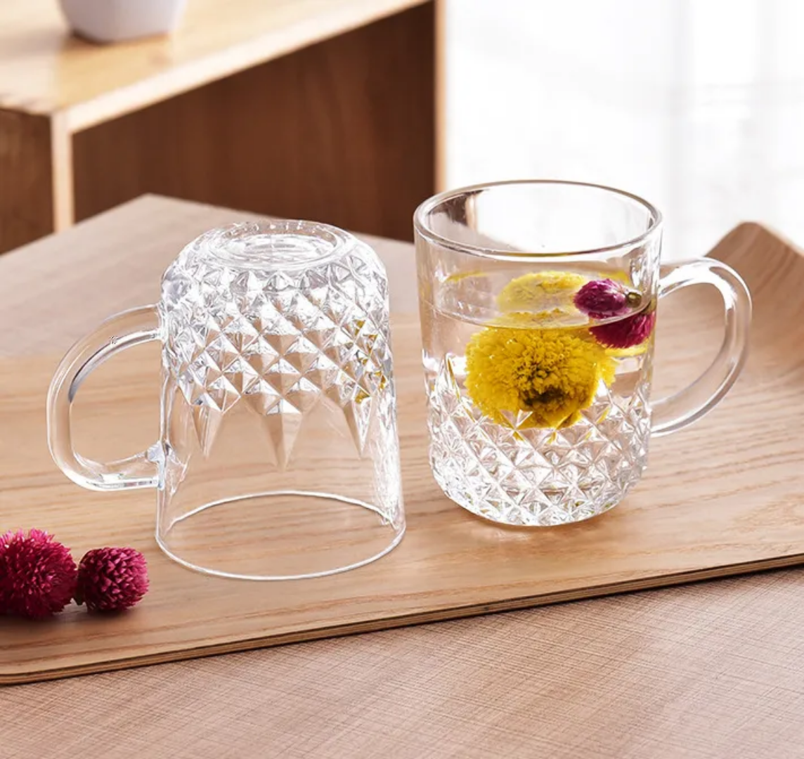 Clear Diamond Cut Tea Cup Set 240ml with two stylish glass cups on a wooden tray, showcasing detailed craftsmanship ideal for kitchen and dining.