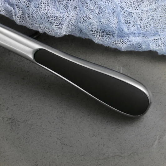 Close-up of stainless steel pizza cutter handle with black non-slip grip. Durable kitchen tool for precise pizza slicing. Pizza Tools Online Sri Lanka.