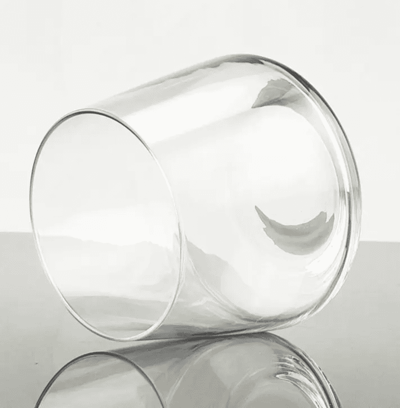 Close-up of empty Seamless Crystal Whisky Glass 400ml lying on its side, highlighting its flawless square base and transparent finish.