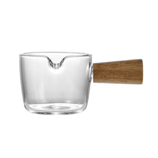 Clear 100 ml Glass Espresso Measuring Cup with spout and wooden handle, designed for precise brewing and heat-resistant performance.