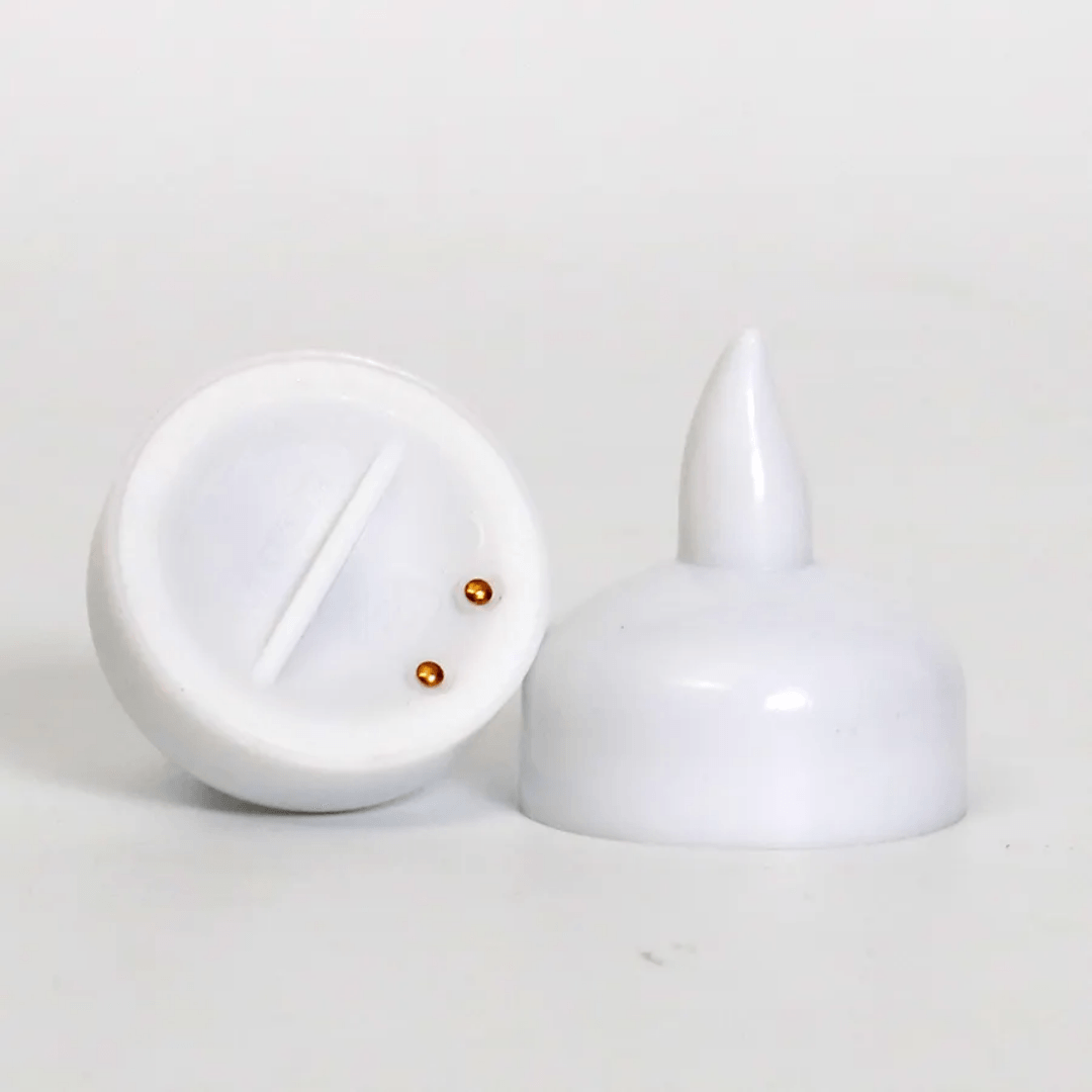 Bottom and side view of waterproof LED floating candle showing battery compartment and contact points; safe flameless lighting option.