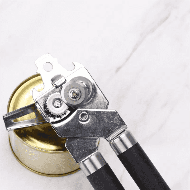 Close-up of Classic Multifunction Can Opener for Kitchen highlighting sharp rotary blade and gear system for smooth tin cutting.