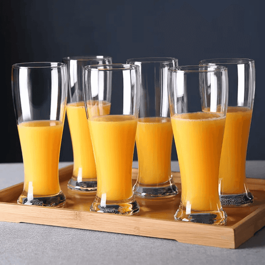 Set of six Mocktail Beer Tumbler Glasses 400 ml filled with orange juice on a wooden tray, perfect for home and garden drinkware use.