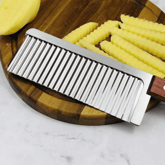 Stainless Steel Crinkle Knife for Perfect Slices shown cutting crinkle-cut potato slices on a wooden board, ideal for food presentation.