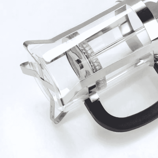 850ml French Press Coffee Maker with borosilicate glass and stainless steel frame, shown from a side angle highlighting its durable design.