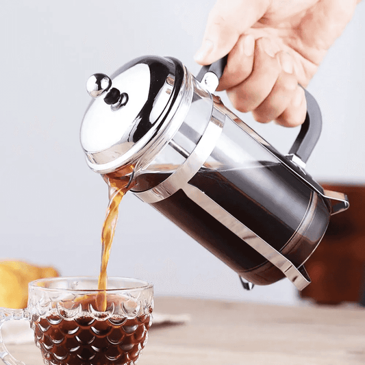 Stainless Steel Coffee Press pouring rich coffee into a glass cup, showcasing smooth brewing from the 600ml Coffee Maker for home use.