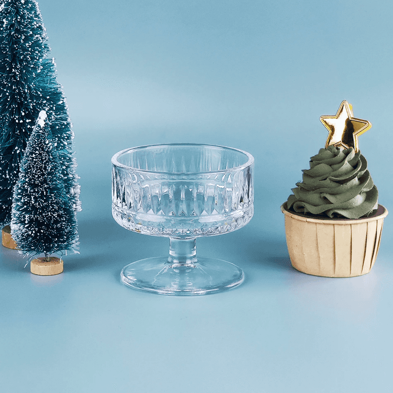 Retro Striped Dessert Cup displayed empty beside festive decor and cupcake, showcasing its vintage charm and durable glass design.