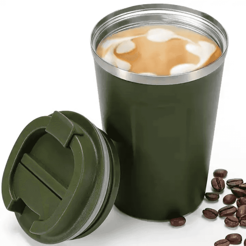 Green 500ml insulated stainless steel travel mug filled with coffee, shown with removable lid and coffee beans beside it.