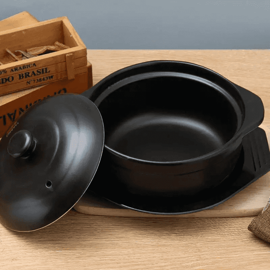 Open 18cm ceramic pot on wooden surface, showcasing durable heat-resistant design perfect for small meal preparation and serving.