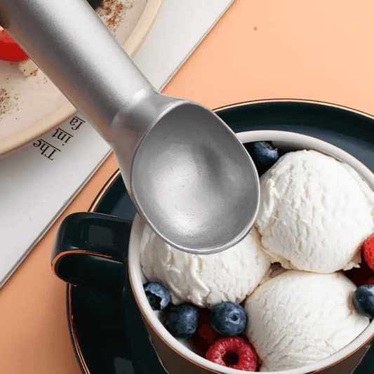 Non Stick Aluminum Scoop for Ice Cream serving vanilla scoops with berries in a dark green cup. Ideal for smooth, effortless scooping.
