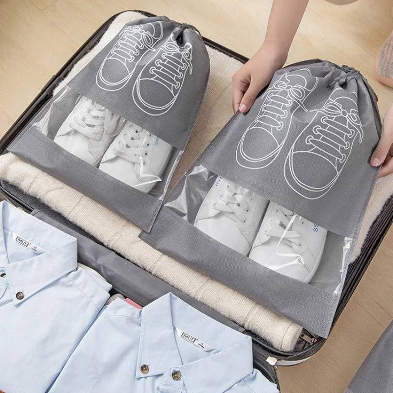 Shoe storage bags for travel neatly packed in a suitcase, showcasing organized packing of white sneakers in durable, portable shoe bags.