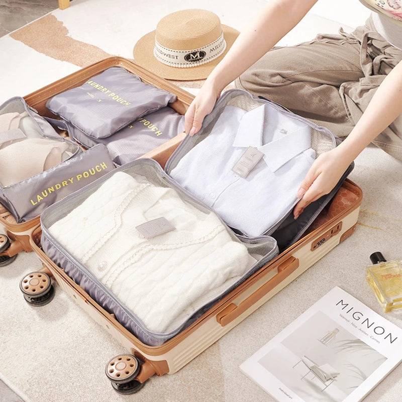 Travel Bag Set - 6PCS Storage Bags neatly packed in a suitcase, showcasing organized clothing for efficient travel packing.