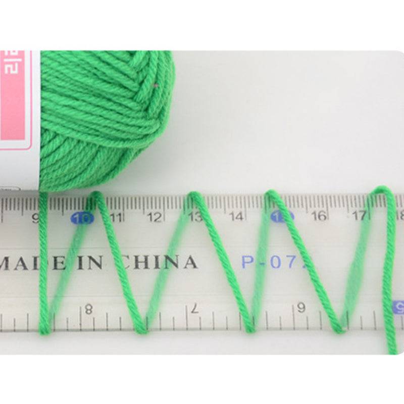 Close-up of green 4 ply cotton yarn from Crochet Knitting Yarn 2PCS measured against a ruler, showcasing thickness and quality.