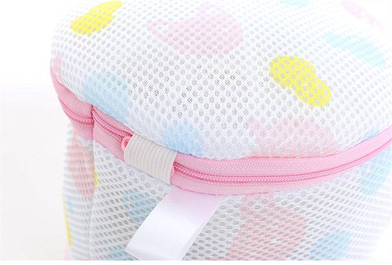Mesh Washing Bag for Safe Underwear Wash with pink zipper and colorful pattern. Durable laundry bag protects delicates in washing machines.
