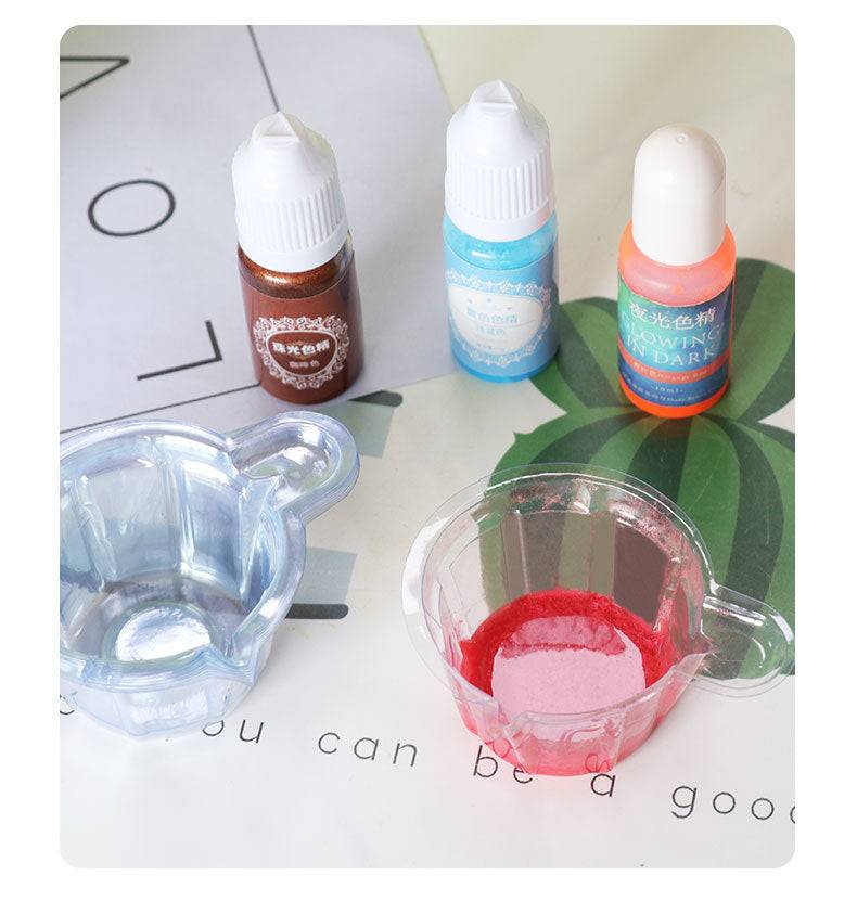 Epoxy Dispensing Cups 10 Pack shown with dye bottles and red pigment. Perfect disposable solution for hand crafting and epoxy projects.