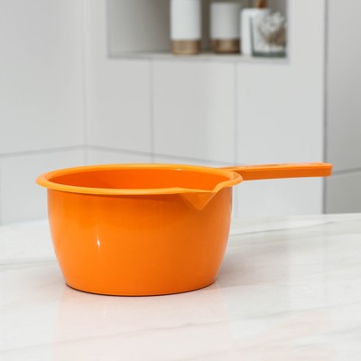 Bright orange plastic ladle with long handle and spout, ideal for kitchen use and food serving. Durable 7-inch kitchen tool for easy pouring.