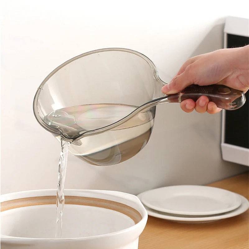 Clear plastic ladle pouring water into a bowl. A versatile kitchen accessory with a sturdy handle for easy grip.