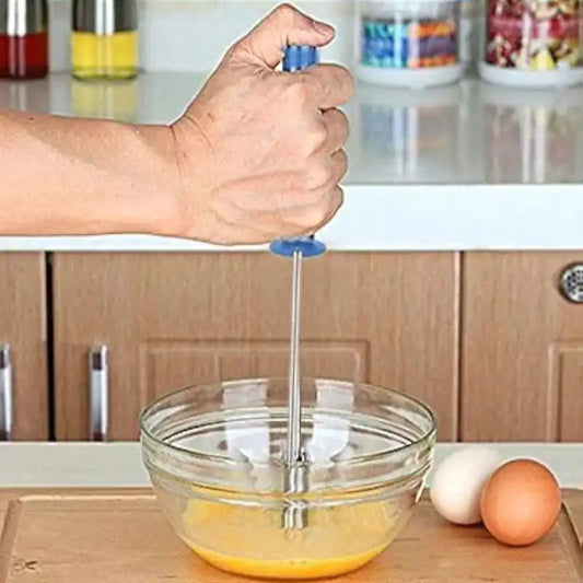Person using stainless steel hand mixer to beat eggs in a glass bowl. Ergonomic handle design perfect for home kitchen use.