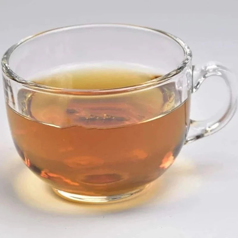 Single clear glass tea cup with amber tea, showcasing the modern design of the 150 ml Glass Tea Cup Set available at Bamagate.com